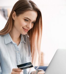 A happy women making an online payment with her credit card